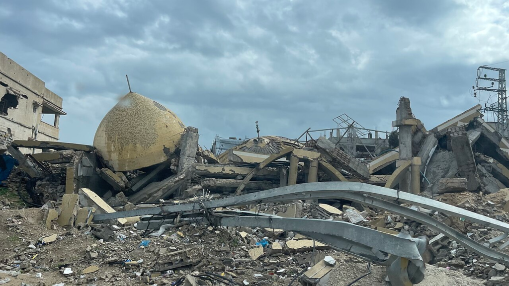 Gaza’s Reconstruction: Who Gets to Decide What Comes Back? 5 A destroyed mosque in the Jabalia area, showing surviving architectural elements within the debris