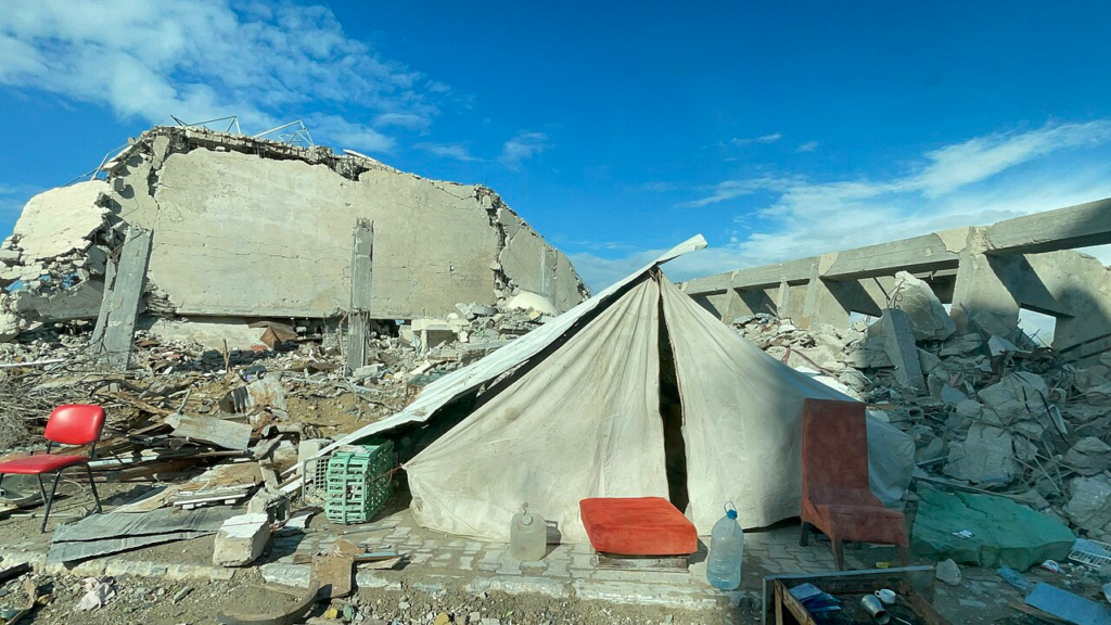 Gaza’s Reconstruction: Who Gets to Decide What Comes Back? 3 A temporary tent erected beside the rubble of a destroyed family home in Gaza