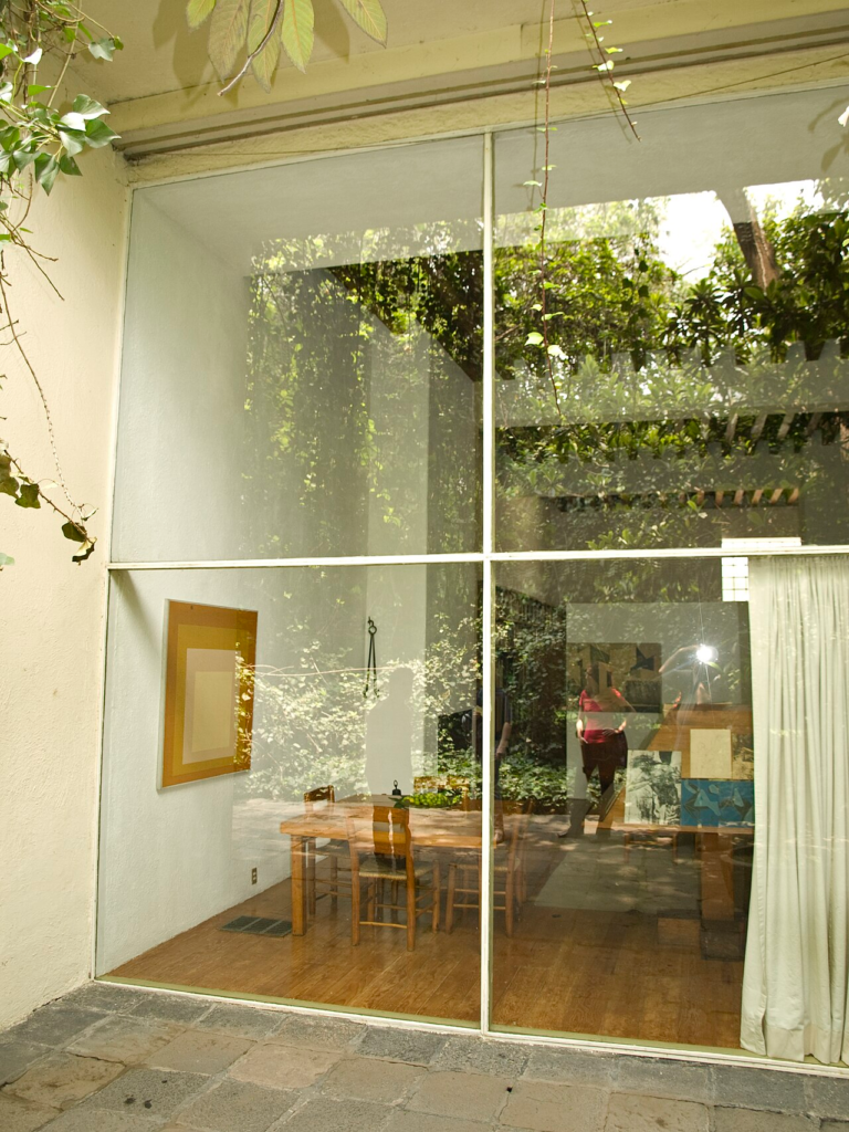 Garden facade of the Luis Barragán House and Studio in Mexico City, showing the interaction of modern spatial language, landscape and filtered light