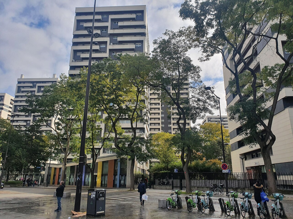 Why the Paris Protests Matter Beyond France: Education, Affordability and Trust 3 Cité Curial Michelet social housing complex in the 19th arrondissement of Paris, showing residential buildings and their surrounding public realm