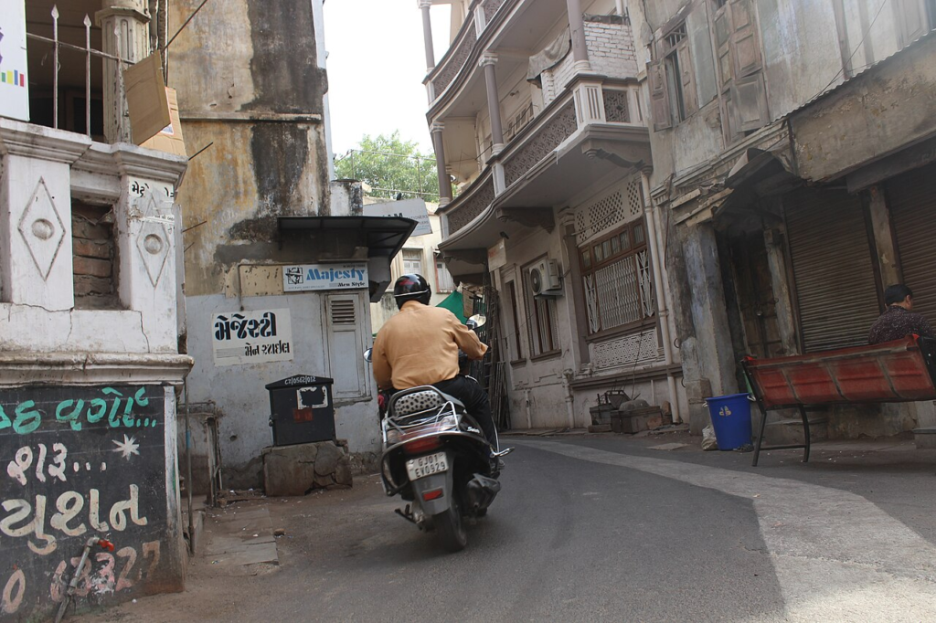 Save It or Demolish It? Who Decides Which Buildings Deserve a Future? 4 Traditional residential streetscape in an Ahmedabad pol, showing closely spaced houses and everyday street use