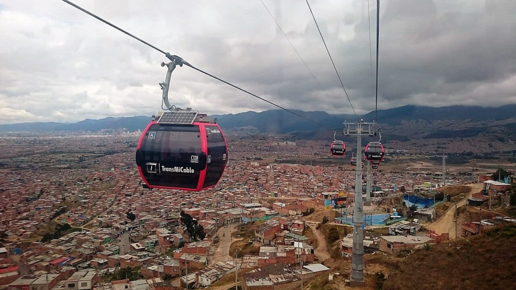 A TransMiCable cabin above Bogotá’s hillside neighbourhoods, illustrating the relationship between residential geography and transport access