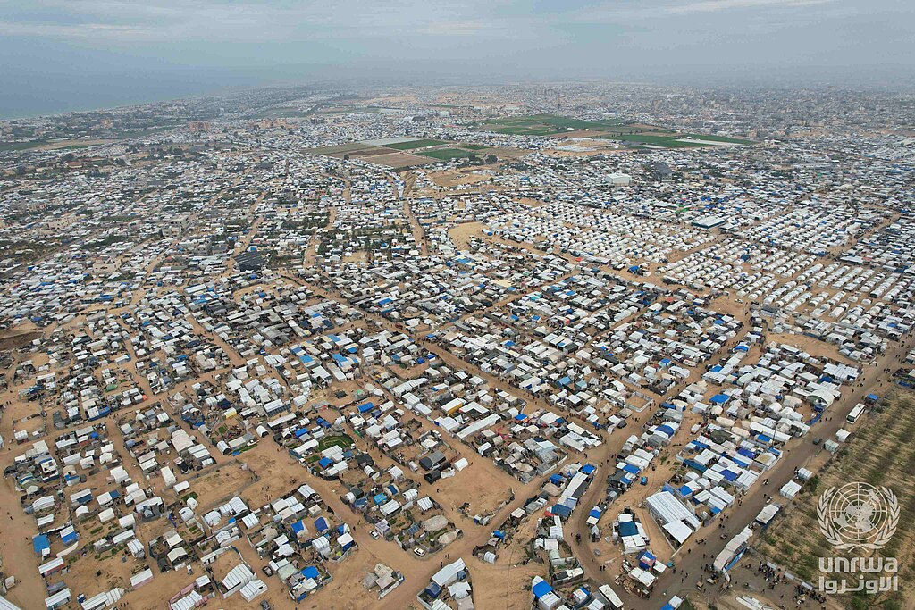 Gaza’s Reconstruction: Who Gets to Decide What Comes Back? 2 Aerial photograph of densely arranged displacement shelters in Al-Mawasi, showing the spatial consequences of mass displacement